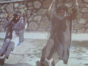 Tribal leaders try out the playground swings at Afghanistan's new girl's high school, built by the community and Greg Mortenson's Central Asia Institute.